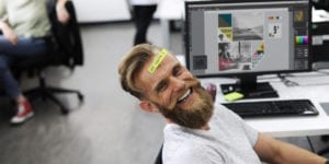 hipster man with post it on forehead